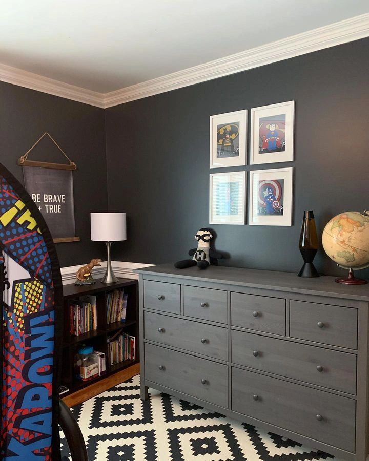 a bedroom with a dresser, bookcase and pictures on the wall