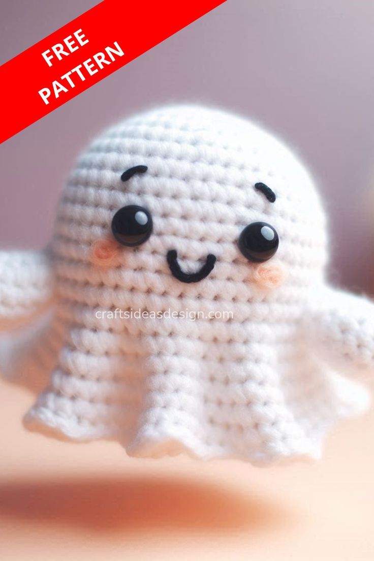 a crocheted white ghost with black eyes