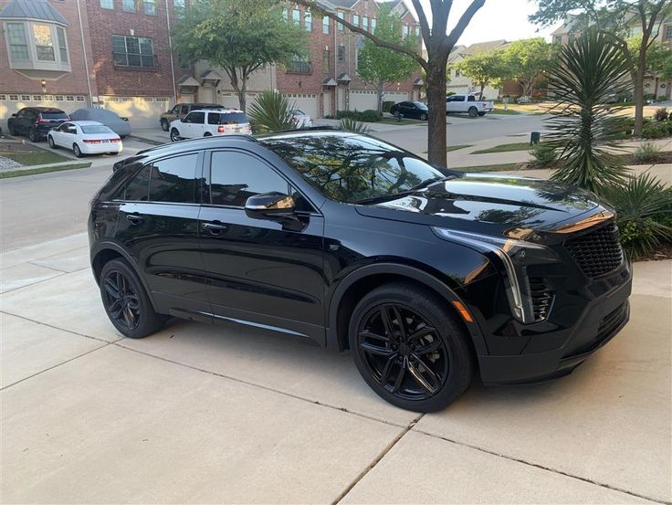 a black suv parked on the side of a street