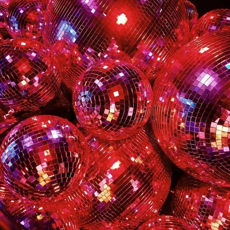 many shiny disco balls are stacked together