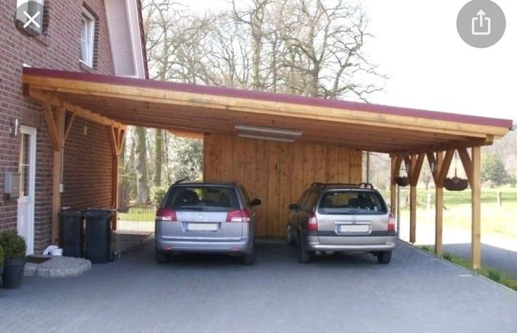 two cars are parked in front of a house with a carport attached to it