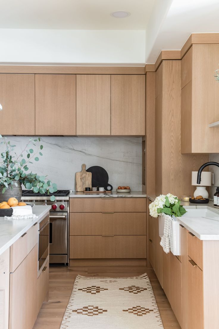 the kitchen is clean and ready for us to use it's natural wood cabinetry