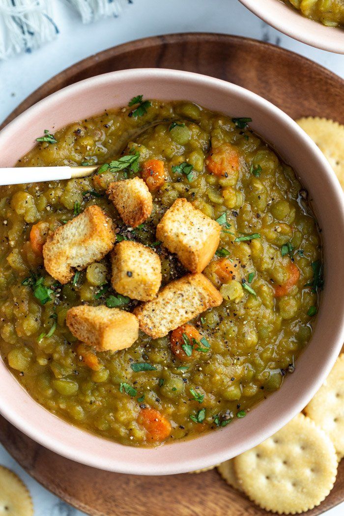 two bowls filled with soup next to crackers