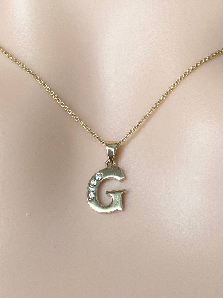 This letter initial pendant is so adorable, minimal and made of solid gold. This dainty initial necklace elegant enough to wear alone or layered with other necklaces. Perfect gift for Valentine's Day, Birthday, Mother's Day or Christmas Gift!!  Details:  Gold: 10K 14K Solid Gold Color: Yellow Gold Size: 10mm approximately  Stone: High Quality Cubic Zirconia Stamped: 417 or 10K, 585 14K Chain: Cable Chain 0.9mm Length: 16-22 inches  Condition: New All Letters are available! Please understand that the photos are ENLARGED to show detail for your benefit- please use the measurements provided in the item details/description to understand the size of the gem or Jewelry in the listing- measurements are given in millimeters unless otherwise noted. Please check the photos & sizes in the description