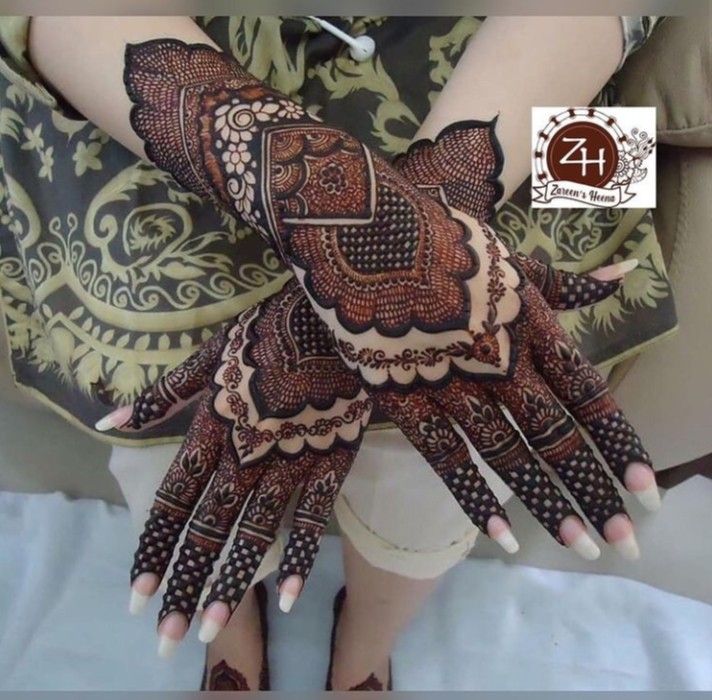 a woman's hands decorated with hennap and intricate designs on her hand