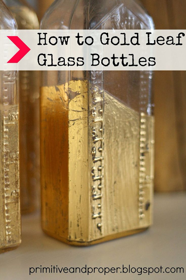 two glass bottles filled with liquid sitting on top of a table