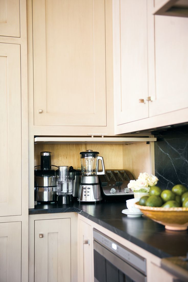 a bowl of fruit sitting on top of a kitchen counter next to an appliance