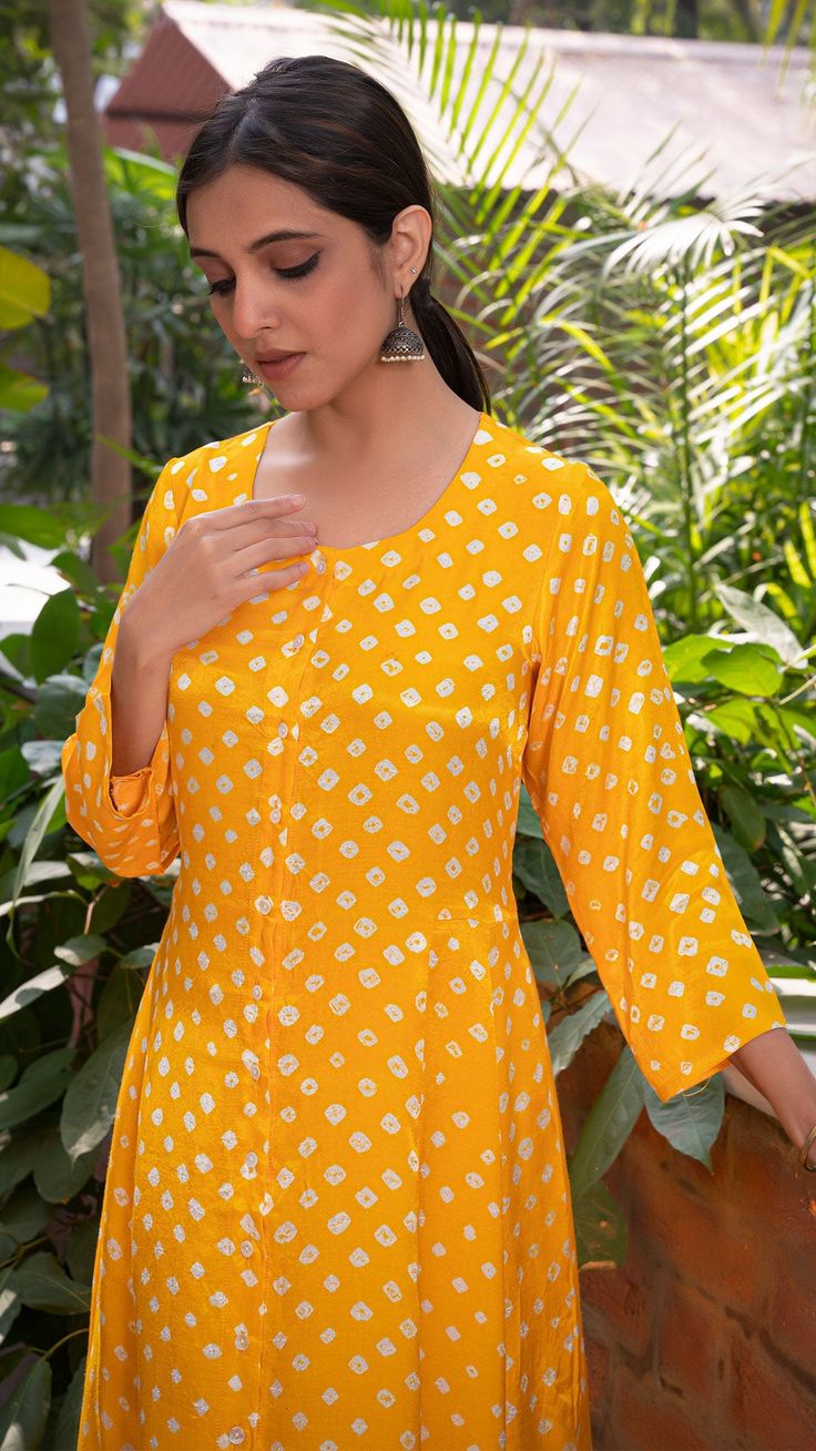 Bring on the festive spirit with our bandhani kurta set. Hand Tie Dyed. Made in modal silk. Flared Kali Kurta with Pallazo Pants. Colour : Yellow. Model height is 5.3” and is wearing a size S. Wash Care : Dry Clean Only. Summer Bandhani Print Sets With Straight Kurta, Bandhani Print Straight Kurta Sets For Summer, Diwali Bandhani Print Palazzo Set With Straight Kurta, Diwali Long Sleeve Bandhani Print Anarkali Set, Festive Bandhani Print Palazzo Set With Straight Kurta, Festive Bandhani Print Salwar Kameez, Festive Anarkali Kurta With Bandhani Print, Anarkali Kurta With Bandhani Print For Puja, Long Sleeve Bandhani Print Sets For Puja