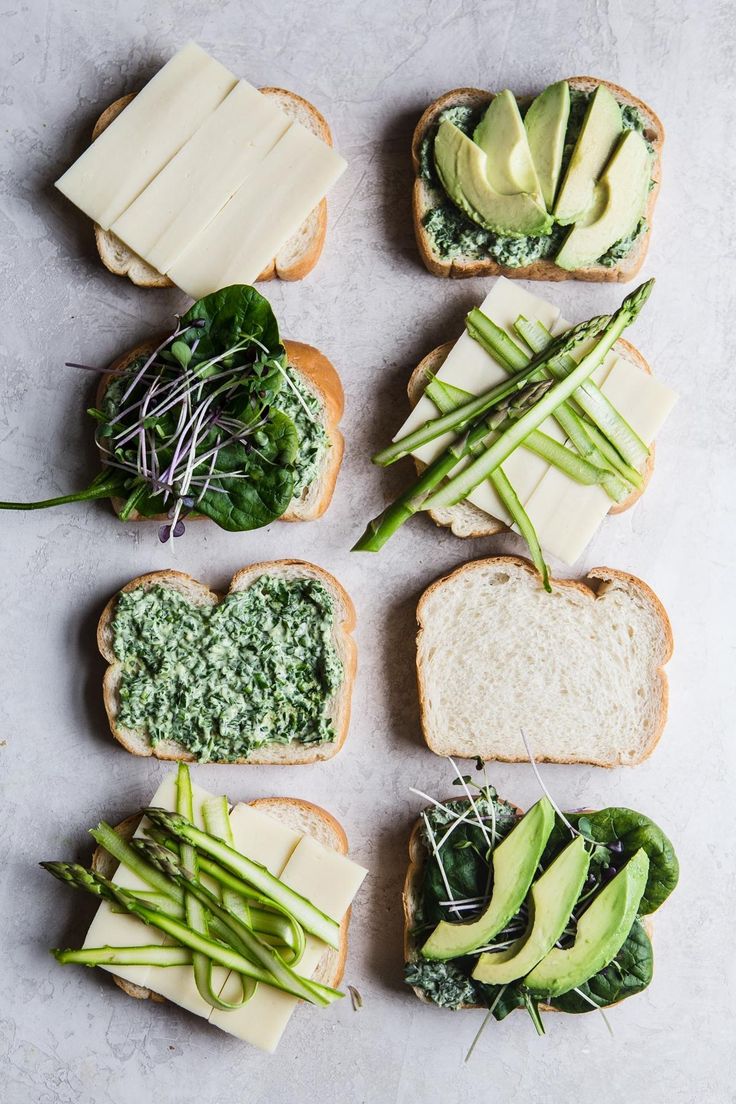 sandwiches with cheese, avocado and spinach on them are arranged in the shape of hearts