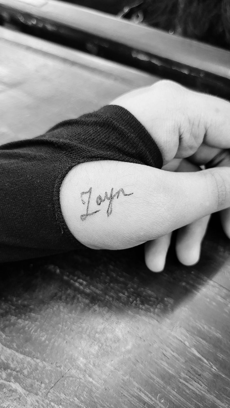 a person's arm with the word joy written on it in cursive writing