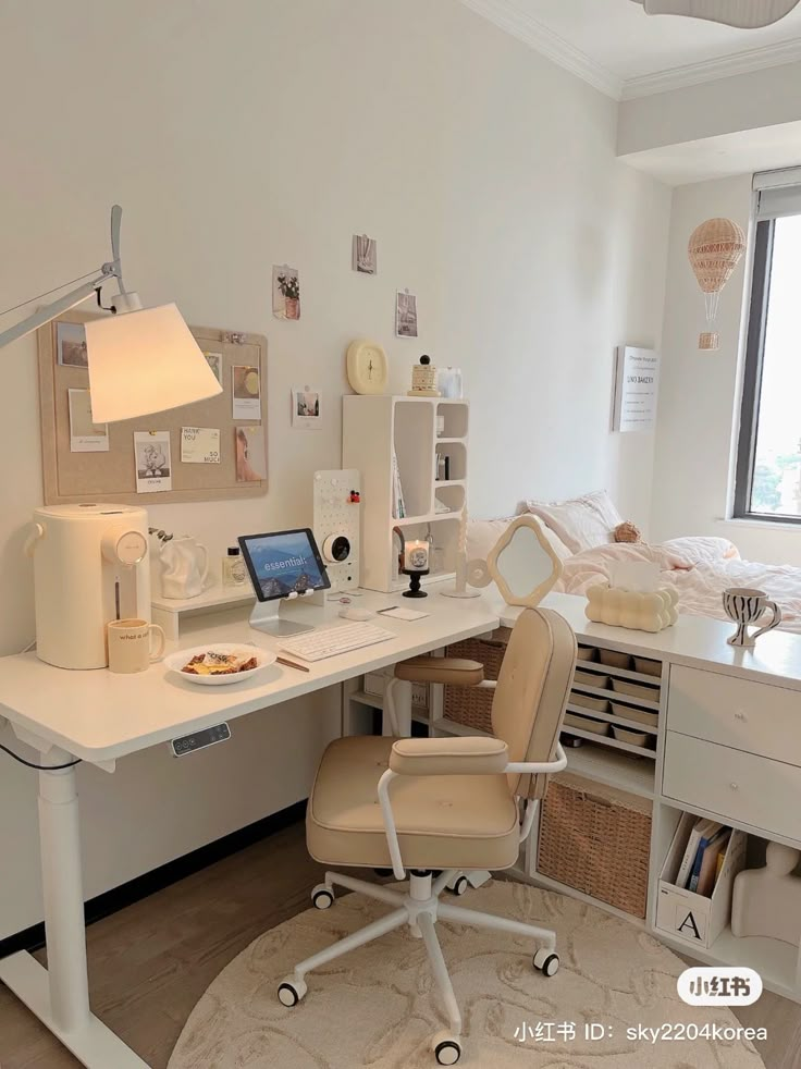 a white desk topped with a laptop computer next to a window