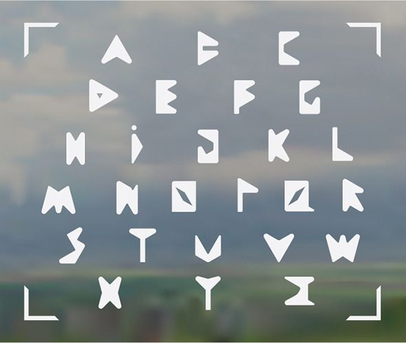 a set of white letters and numbers on a gray background with clouds in the distance