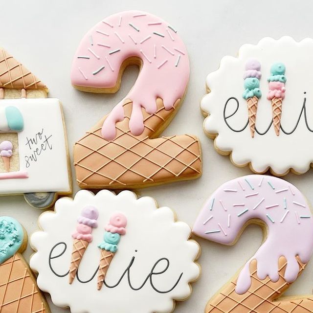 decorated cookies with ice cream and donuts are arranged in the shape of number two