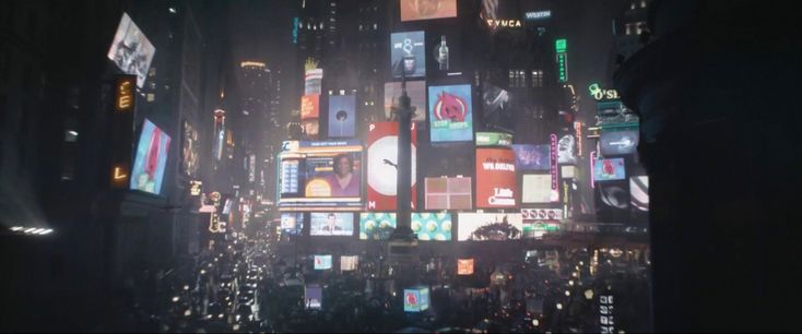 a city filled with lots of tall buildings covered in billboards and lights at night