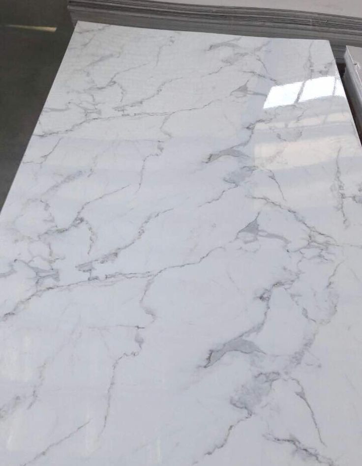 a white marble counter top in a kitchen