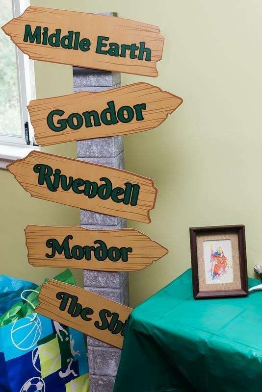 a wooden sign that says middle earth, gondor, riverdale, mirror, the sky