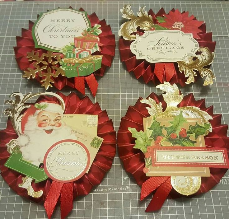 four red ribbons with santa's christmas greetings attached to them on a cutting board