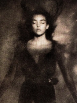 a black and white photo of a woman in motion