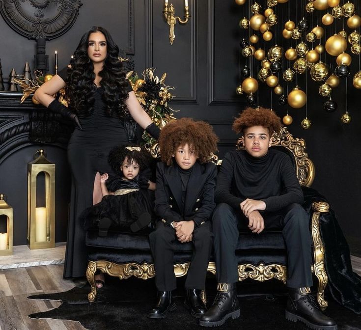 the family is posing for a photo in their black and gold christmas cardigans