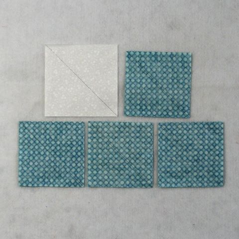 four pieces of blue and white fabric laid on top of each other