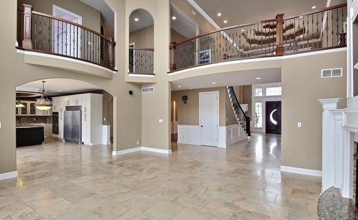 a large open floor plan with stairs leading up to the second story