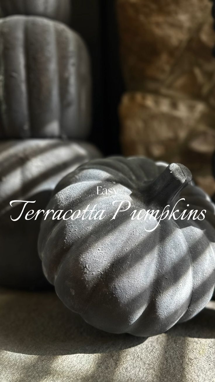 a black pumpkin sitting on top of a table