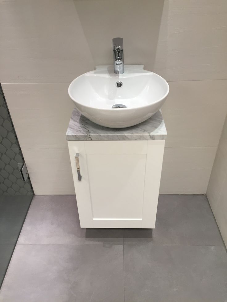 a white sink sitting on top of a counter in a bathroom