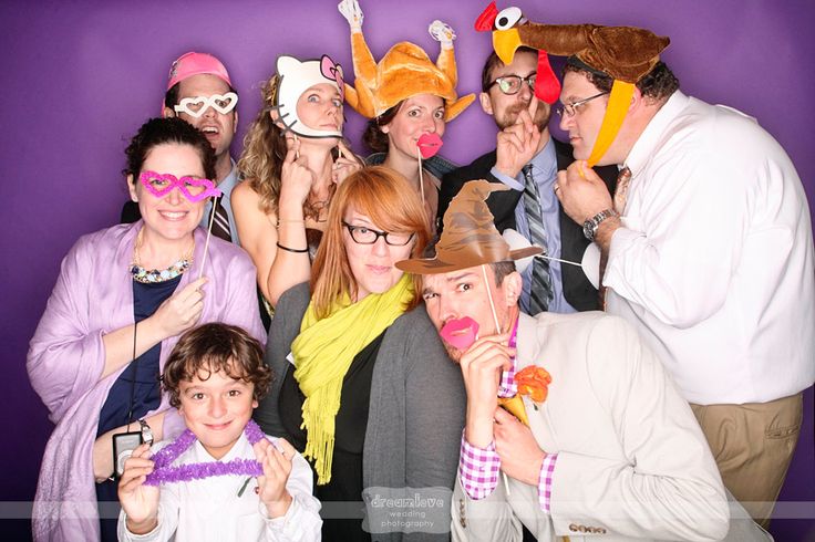 a group of people posing for a photo with props on their heads and hands in front of them