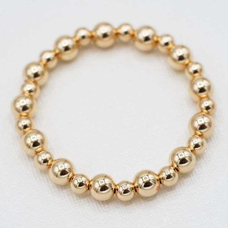 One of our classics from the beaded lux collection. Stack the alternating sized bead bracelet with a chain bracelet for a well-rounded arm party. This style is created with one of our "stretchy" cords for easy wear and effortless bracelet stacking. Bracelet is made with 6mm and 8mm alternating goldfill beads. We want to make sure your stretch bracelet has the perfect fit, so we have created sizing options to select above. Please contact us if you have any sizing questions or would like a custom Adjustable Yellow Gold Stretch Bracelet With 8mm Beads, Classic Yellow Gold Stretch Bracelet Hand-strung, Classic Stackable Beaded Bracelets, Classic Yellow Gold Hand-strung Stretch Bracelet, Classic Yellow Gold Stretch Bracelet As Gift, Classic Hand-strung Yellow Gold Stretch Bracelet, Classic Yellow Gold Stretch Bracelet, Classic Adjustable Jewelry With 8mm Beads, Classic Stackable Stretch Bracelet With Round Beads