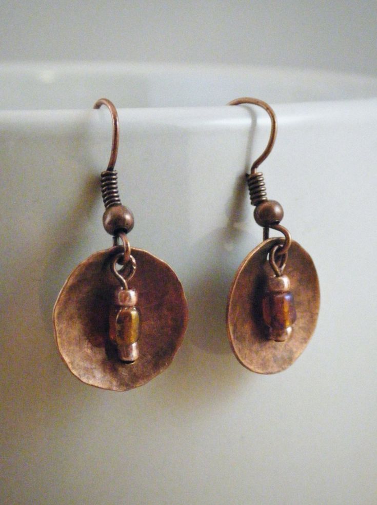 "These textured copper discs are teamed up with coordinating beads of bright copper and iridescent glass beads. Cute earrings are paired with copper coated fishhook earwires for a complete look. Discs are 15mm copper coated brass. Earring measure 1.25\"  Your earrings will arrive in a kraft gift box with contrasting raffia ribbon. Gift boxes are 100% recycled cardboard boxes (made with 77% post-consumer fiber and 23% pre-consumer fiber). Boxes are made in USA." Bronze Round Bead Copper Earrings, Bronze Copper Earrings With Round Beads, Nickel-free Bronze Beaded Copper Earrings, Bronze Copper Jewelry With French Hook, Wig Jig, Raffia Ribbon, Abalone Jewelry, Bright Copper, Ribbon Gift