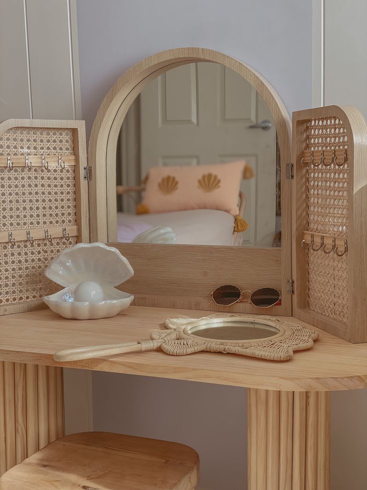 a wooden vanity with a mirror and stool