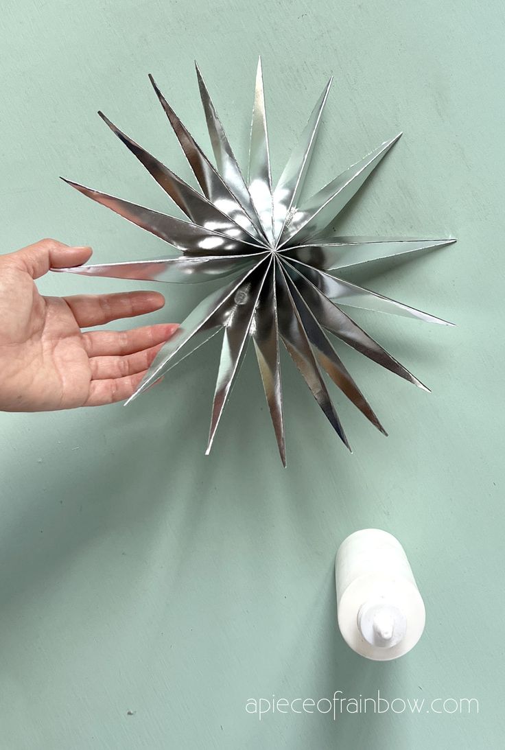 a hand reaching for an object made out of metal