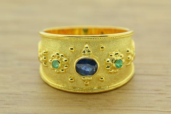 The beauty of Byzantine style jewelry, completely handcrafted in Greece with the old-fashioned way, is omnipresent. An outstanding 14K solid yellow gold ring with Byzantine design decorated with genuine gemstone oval sapphire, round emeralds remains a classic and elegant choice for everyone. Bold and traditional, you will not take your eyes over your finger. Neither will your friends! High Quality Handmade Greek jewelry!★Dimensions : Top’ s width: 0.50 inches★High quality product.★ In a gift box Antique Emerald Ring In Gold With Oval Cabochon, Antique Gold Emerald Ring With Oval Cabochon, Gold Multi-stone Oval Sapphire Ring, Gold Oval Sapphire Ring With Multi-stones, Gold Multi-stone Sapphire Ring With Oval Shape, Gold Multi-stone Oval Cabochon Ring, Heirloom Style Oval Cabochon Sapphire Ring, Antique Gold Emerald Cabochon Ring, Heirloom Gold Emerald Ring With Oval Cabochon