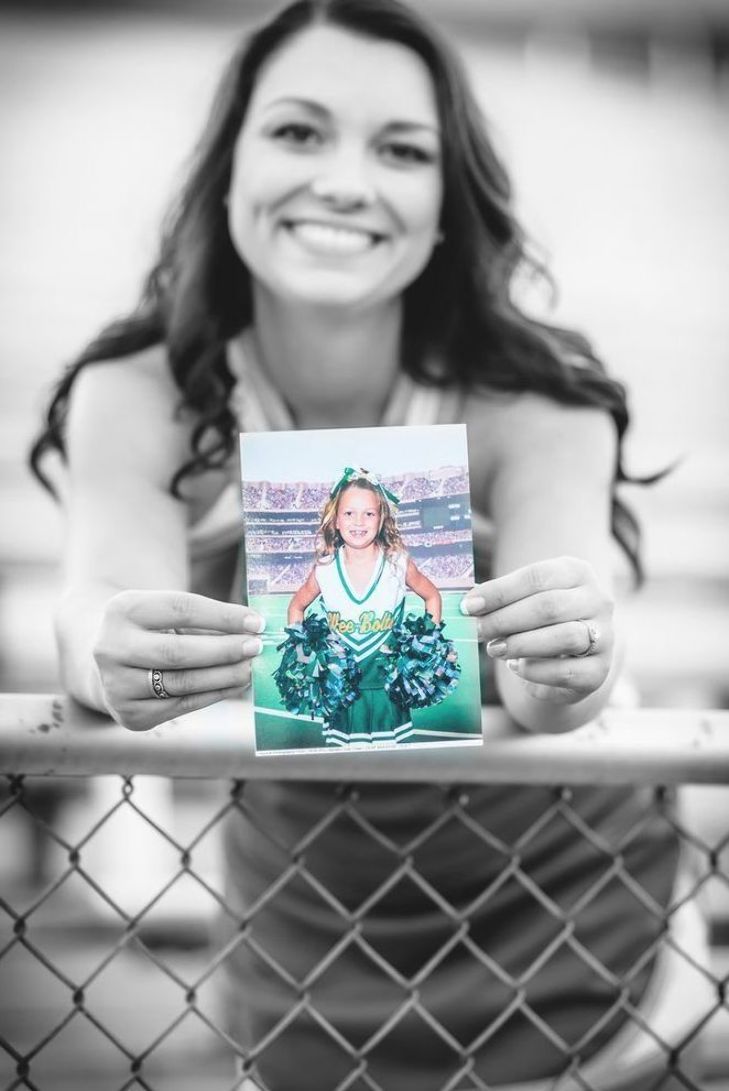 a woman holding up a card in front of her face with the image of a cheerleader on it