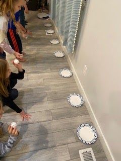 children are playing with paper plates on the floor