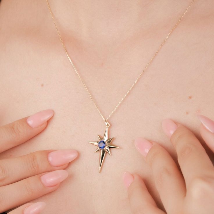 Discover the elegance of our 14K Gold Blue Sapphire North Star Pendant. This exquisite piece features a stunning blue sapphire at its center, representing the Polaris star. Perfect as birthstone jewelry, it makes an ideal birthday gift for someone special. The North Star design adds a celestial touch, making it a beautiful and meaningful accessory for any occasion. This pendant is perfect for layering, adding a touch of sophistication to any outfit. Product Features: * Made to Order: Crafted specifically to your preferences. * Gold KT: 14K Solid Gold (stamped) * Gold Weight: Approximately 1.75 grams Only Pendant( Without Chain)  * Gemstone; Blue Topaz  * Chain Lengths: Choose from a range of lengths, from 14" to 24" (36cm to 61cm), to suit your preference. * The chain style is cable. All c Anniversary Star-shaped Birthstone Jewelry, Elegant Birthstone Necklace With Star Of David, Blue Sapphire Birthstone Necklace For Gift, Blue Sapphire Birthstone Necklace Gift, Celestial Star Sapphire Jewelry, Elegant Blue Jewelry With Star Charm, Elegant Blue Star Charm Jewelry, Fine Jewelry Sapphire Birthstone Necklace As A Gift, Star-shaped Gemstone Jewelry For Formal Occasions