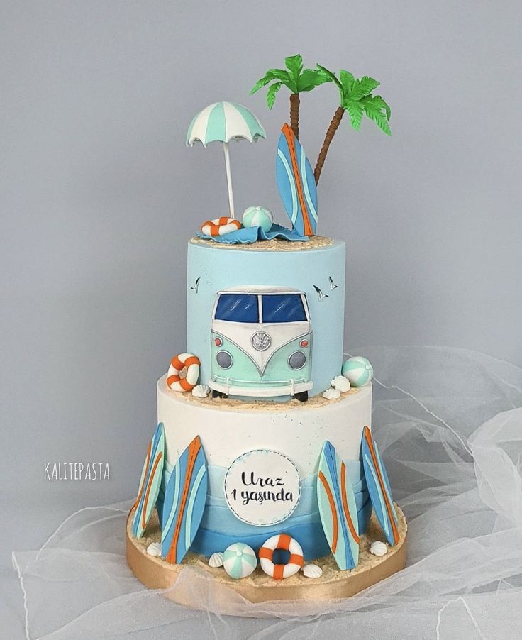 a three tiered cake decorated with a vw bus and palm trees on top