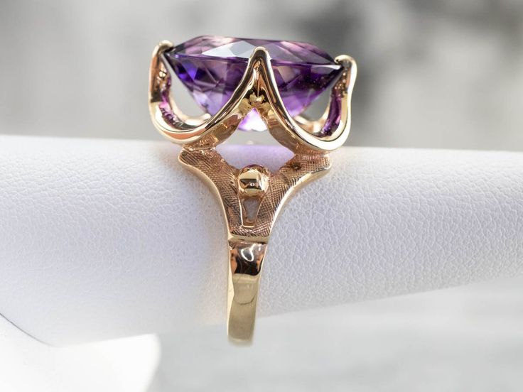 This ring is truly gorgeous! A large and beautiful deep purple amethyst sits in the center, with an amazing cut and vibrant purple color that flickers with bright pops of violet and raspberry undertones. The stone is expertly cut to really display the stone’s color and sparkle! Metal: 14K Yellow Gold Gem: Amethyst 10.62 Carats Gem Measurements: 12.9 x 17.3 mm, Oval Ring Size: 8.25 Marks: "14K" Stamped on the inside band Antique Amethyst Ring, Yellow Gold Amethyst Ring, Yellow Gold Sapphire Ring, Amethyst Cocktail Ring, Gold Drop Necklace, Gold Amethyst Ring, Right Hand Ring, Cameo Ring, Right Hand Rings