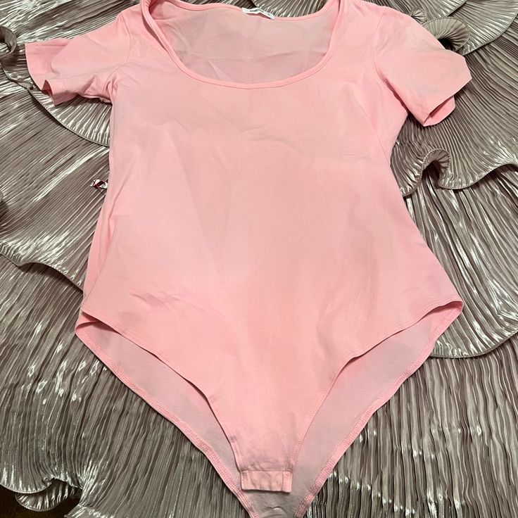 Gently Used Worn Once Bodysuit Looks Brand New. There Is A Small Hole In The Crotch Area There Is A Photo Of It Fitted Pink Short Sleeve Casual Bodysuit, Trendy Fitted Summer Leotard, Pink Stretch Bodysuit With Short Sleeves, Pink Short Sleeve Bodysuit For Summer, Pink Stretch Short Sleeve Bodysuit, Summer Stretch Bodysuit With Scoop Neck, Casual Pink Short Sleeve Bodysuit For Summer, Trendy Stretch Summer Leotard, Trendy Stretch Leotard For Summer