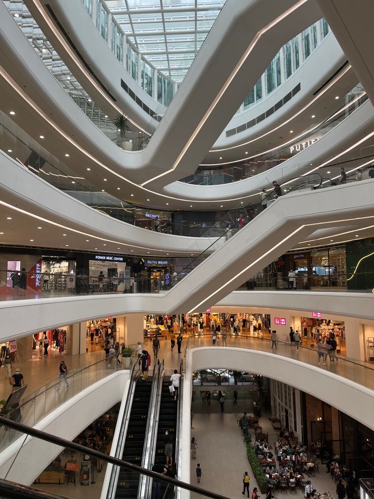 the inside of a shopping mall with people walking around