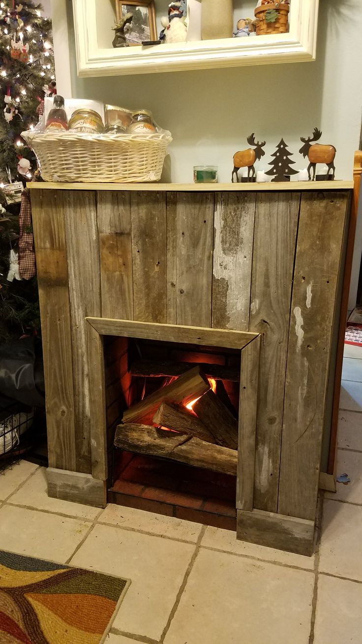 a fireplace in a living room next to a christmas tree