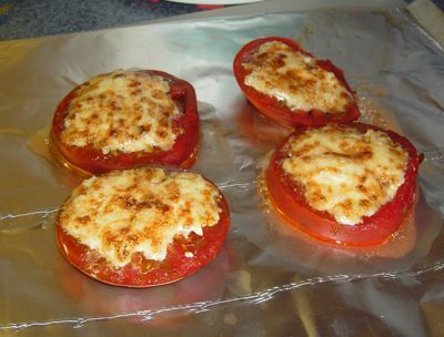 four stuffed tomatoes sitting on top of aluminum foil