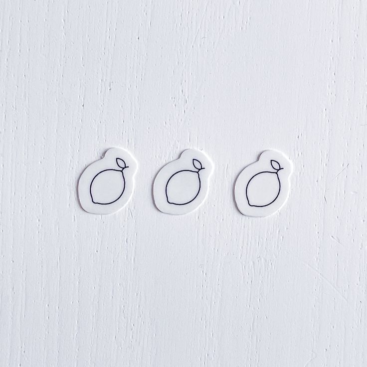 three buttons with the shape of an egg and two smaller ones are on a white surface