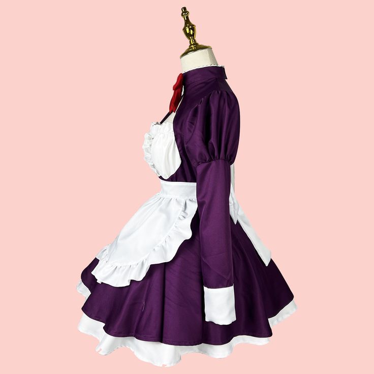 a purple and white dress with ruffles on the skirt is hanging from a mannequin's head