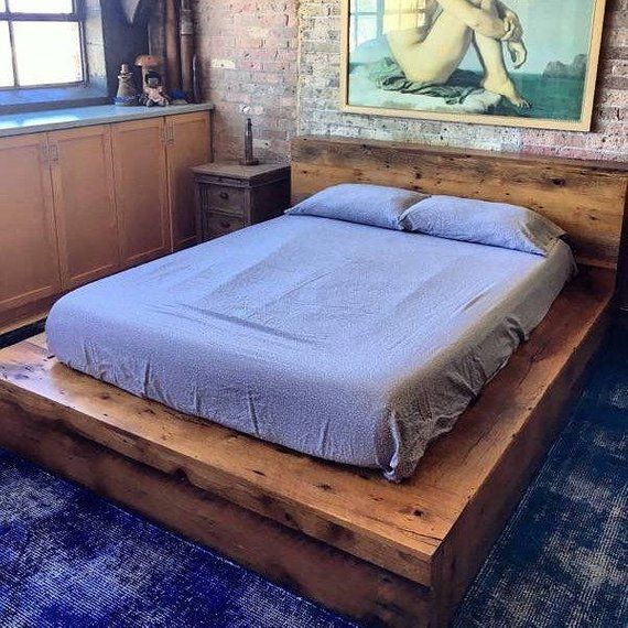 a large bed sitting in the middle of a bedroom next to a painting on the wall