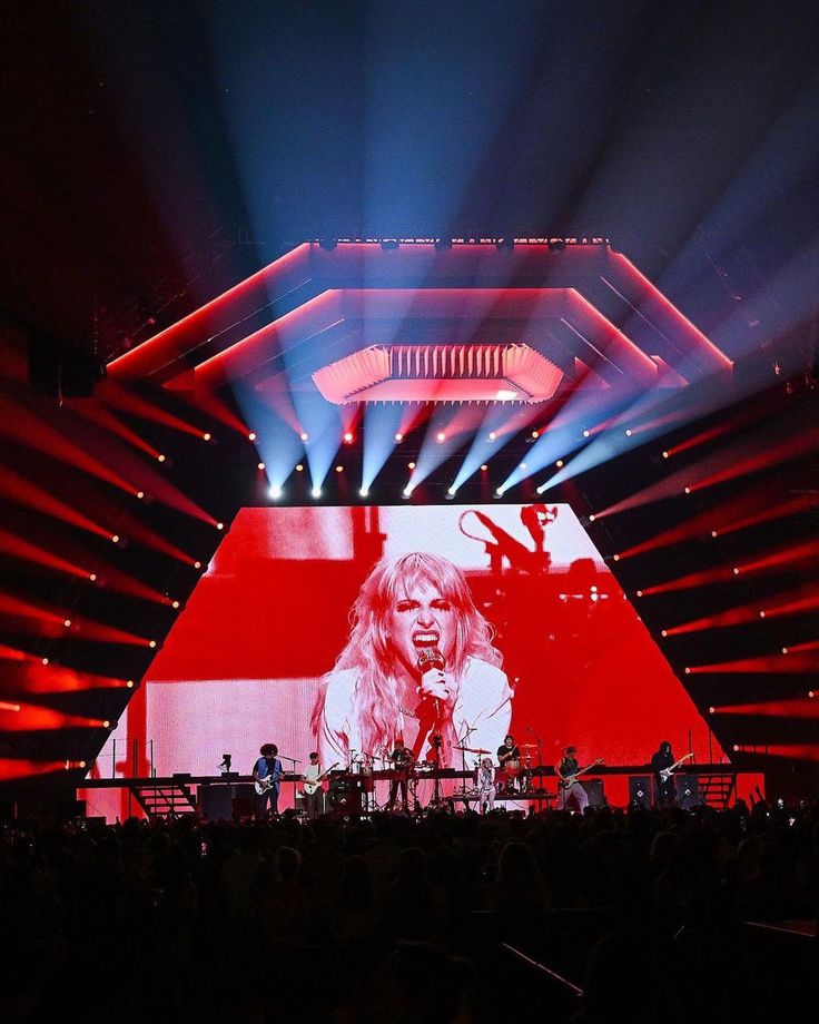 the stage is lit up with red and blue lights