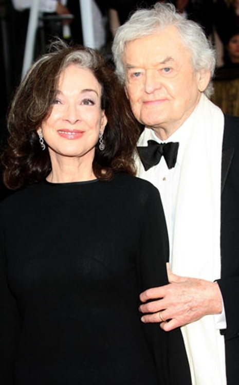 an older man and woman standing next to each other