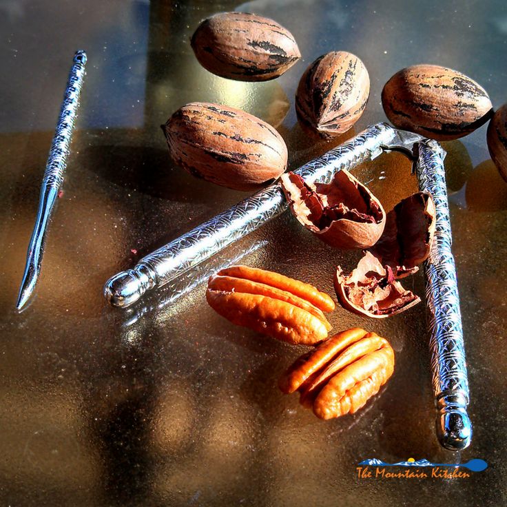 nuts and nutcrackers sitting on a table next to a metal barbwire