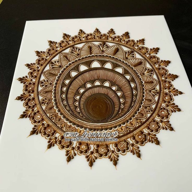 an intricately designed greeting card with gold foil on white paper, featuring a circular design