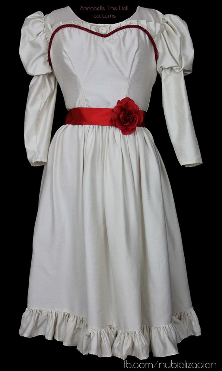 a white dress with a red flower on the waist